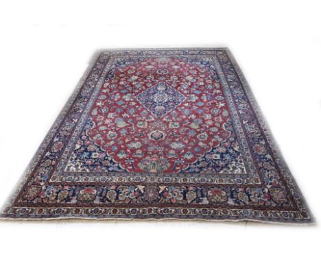 Large hand-knotted Persian carpet with beautiful floral decoration. Colour: Red with blue. Dimensions: 370 x 270 cm. In good 
