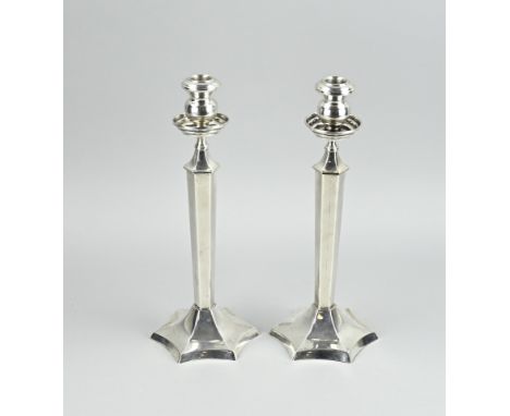 Two beautiful silver candlesticks, 900/000, with a hexagonal base and pillar, provided with a round light.. 11,5x11,5x30cm. T