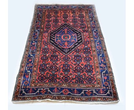 Hand-knotted Persian carpet. Colour: red, blue. Dimensions: 238 x 138 cm. In good condition.