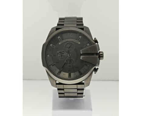 Large Diesel watch with a gold-plated case and a chronograph function. Attached to a black leather strap. ø 52 mm. Working. 0