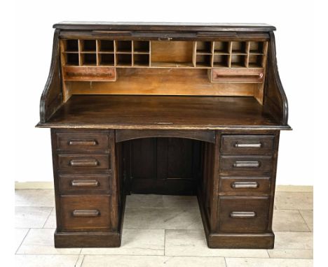Oak English roller desk. Circa 1900. Desk has four drawers on both the left and right. Top with a roller and with various dra