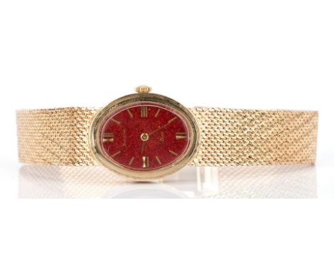Vintage Bulova Dior 14K yellow gold ladies wristwatch having a red dial with gilt Roman numeral markers, 17 jewel movement, m