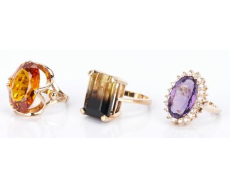 3 Ladies Gold and Gemstone Rings. 1st item: Ladies 10K yellow gold ring featuring an oval Grossularite-Andradite garnet appro