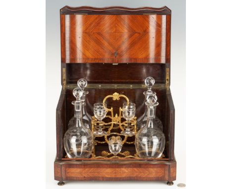 European tantalus or portable liqueur cabinet, mixed woods marquetry case with engraved brass trim and brass feet. Shaped, hi