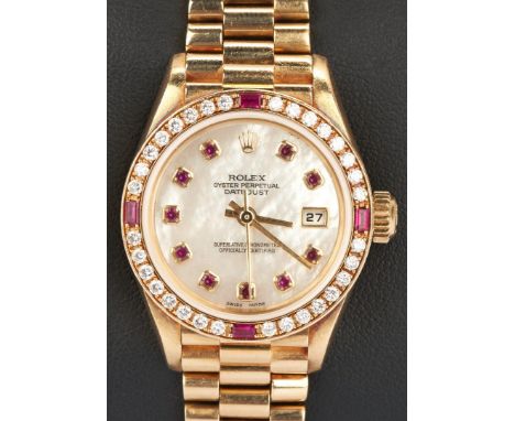 One ladies 18k yellow gold datejust Rolex watch with President bracelet, mother of pearl dial, automatic rewinding movement. 