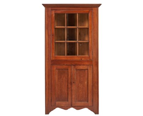 Southern, possibly Virginia, one-piece cherry corner cupboard, yellow pine secondary wood. Top with an ogee cornice over one 