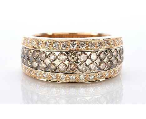 One ladies 14k yellow gold tapered band measuring 9.2mm to 5.7mm paved in the center with 2 rows of 15 chocolate color round 