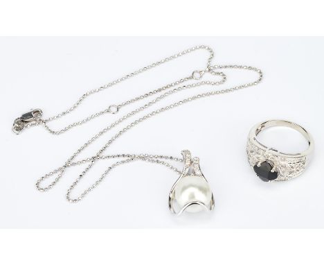 Two (2) ladies gold jewelry items. 1st item: One ladies 14k white gold onyx and diamond occasional ring set in the center wit