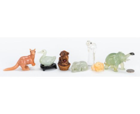 Group of seven (7) Asian carved animal figurals of various materials, including one (1) carved celadon jade duck with stand, 