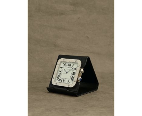 Cartier. Pendulette de voyage en acier avec alarme et etui en cuir mouvement quartzCartier. A stainless steel quartz travel a