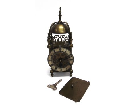 A 20TH CENTURY BRASS CASED LANTERN CLOCK  of traditional form, with silvered chapter ring applied with Roman numerals, the mo