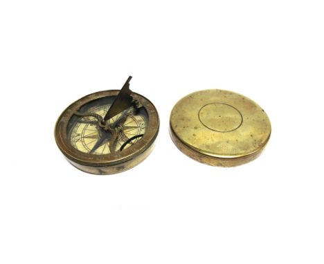 A BRASS POCKET SUNDIAL & COMPASS  with a folding gnomen, the chapter ring engraved in Roman numerals from 4 to 12 then onward