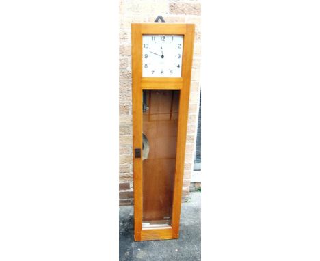 A 'GENTS OF LEICESTER' ELECTRIC CLOCK with enamel dial, in light oak case, with bracket for wall hanging, height 132cm width 