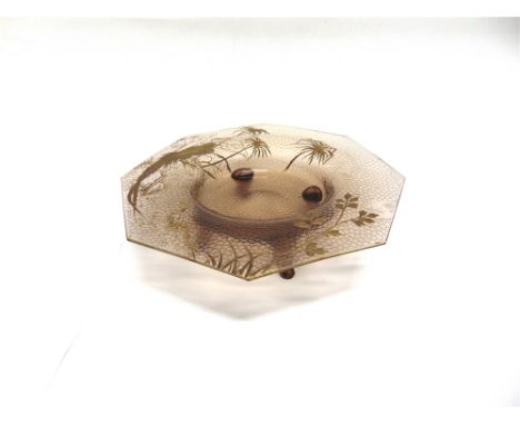AN ART GLASS BOWL  of octagonal dished form on four prong feet, with gilt decoration, probably French, 28cm diameter