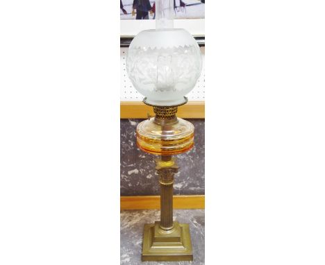 A Victorian oil lamp, etch globe, glass reservoir, brass Corinthian column