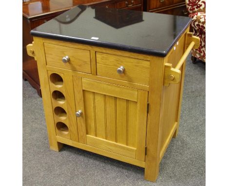 A light oak kitchen centre unit, granite top, two short drawers over cupboard door and wine bottle apertures to each side, to
