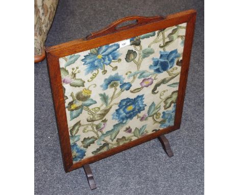 An oak framed woolwork firescreen