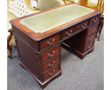 A reproduction Regency mahogany pedestal desk, tooled green leather inlaid writing surface, two small drawers flanking remova