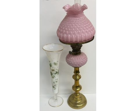 A pink glass oil lamp with a matching shade on a brass column together with a floral decorated glass vase