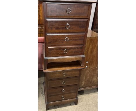 A pair of stag bedside chests each with four drawers on bracket feet