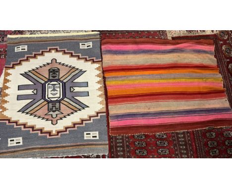 A wall hanging, possibly Mayan in muted colours, 120 x 160cm together with a multicoloured wall hanging / rug