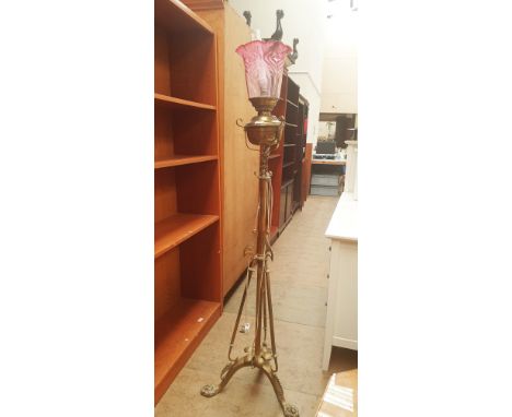 A brass standard lamp with adapted brass oil lamp base and graded glass shade