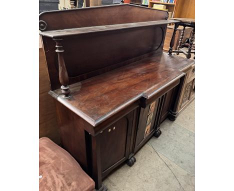 A Victorian mahogany chiffonier with a raised back and shelf, the base with a rectangular top, three drawers and three cupboa