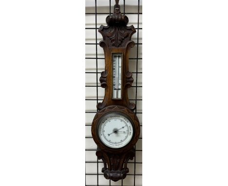 An oak framed aneroid barometer