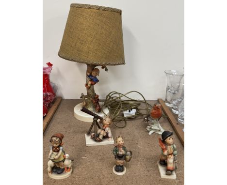 A Hummel lamp with a boy climbing a tree away from a terrier together with four other Hummel figures and a Goebel robin
