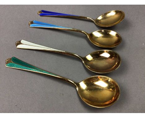 CASED SET OF FOUR SILVER GILT AND HARLEQUIN ENAMEL TEASPOONS,by M. Thune, NorwayTeaspoons are in good condition with no damag