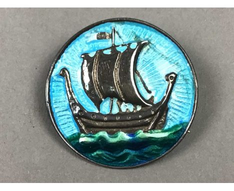 ALEXANDER RITCHIE OF IONAcircular silver and enamel brooch, decorated with a Viking ship, stamped to reverse, along with anot