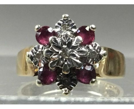 RUBY AND DIAMAND RING,set with round rubies and diamond chips, in nine carat gold, size L