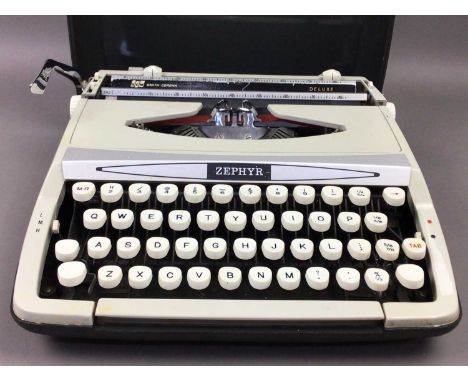 ZEPHYR TYPE WRITER,scm Smith-Corona Deluxe, along with a cased camera set and a boxed pen (3)