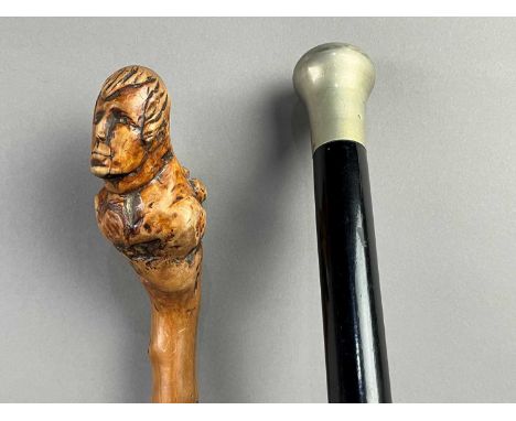 HOLLY WALKING STICK,with carved bust of Burns handle, along with an ebonised cane (2)