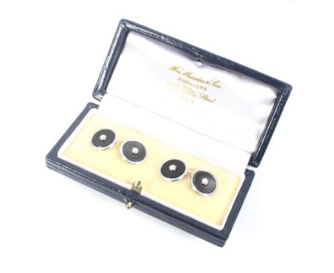 A pair of vintage 9ct white gold, black-onyx and seed pearl round twin panel cufflinks. With chain interlinks, hallmarks for 