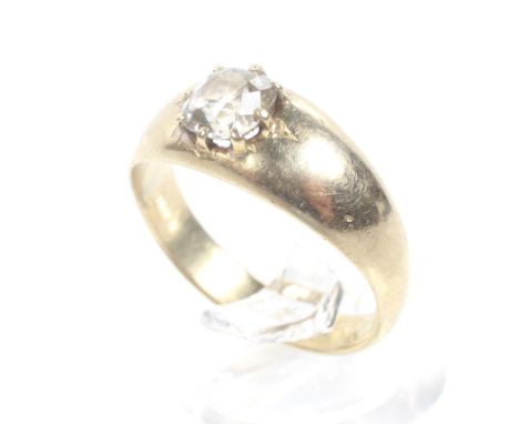 An early 20th century gold and diamond solitaire ring. The cushion-shaped old-cut stone approx. 0.78cts, claw set on a taperi