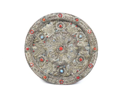 A circa 1900 East Asian circular adazed back wooden plate/plaque. With applied repousse brass, copper etc., and coral and ban