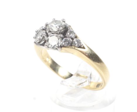 A vintage Continental diamond nine stone abstract cluster ring. The round brilliants approx. 1.00ct total, all claw set in wh