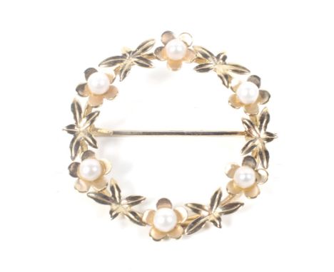 A vintage Scottish 9ct gold and pearl brooch. In the form of an open floral circlet formed of small pearl flower-heads with l