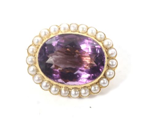 A late Victorian gold, amethyst and half-pearl oval brooch. The oval mixed-cut amethyst approx. 20cts, millegrain set within 