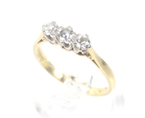 A vintage 18ct gold and diamond three stone ring. The graduated round brilliants approx. 0.36cts total, all claw set between 