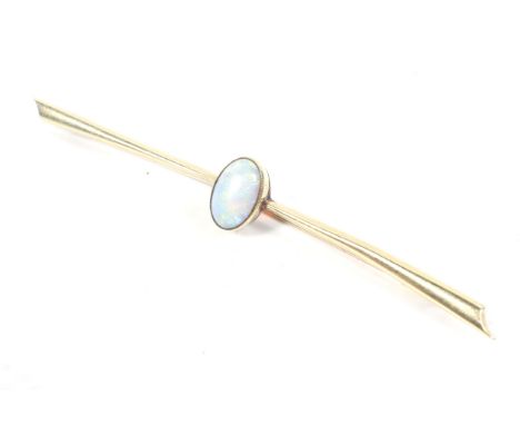 An early 20th century rose gold and opal single stone bar brooch. The oval cabochon white opal displays a pleasing play of mo