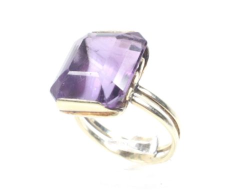 A vintage gold and amethyst single stone ring. The cut-corner rectangular step-cut amethyst approx. 15.20cts, set to an openf