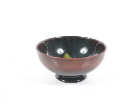 A William Moorcroft flambe bowl. With tubelined decoration in a  tropical 'floral' design on a red and blue ground, H5cm Cond
