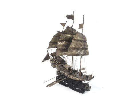 A Chinese export silver-plated model of a Junk. Modelled with three masts in full sail and a deck with three cannons and a fi