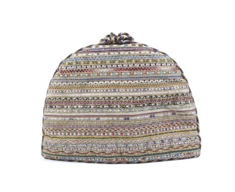 A late Victorian tea cosy commemorating the Diamond Jubilee of Queen Victoria. The woven fabric exterior extensively hand emb