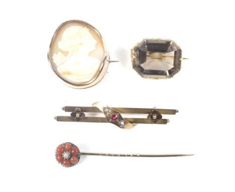 Thee Victorian and later gold brooches and a stick pin. Comprising; a gold-mounted cut-corner rectangular pale smokey quartz 