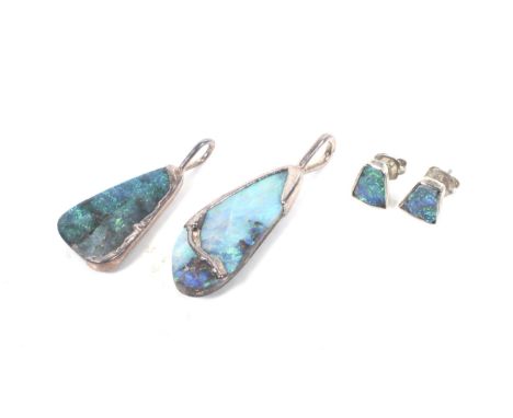 A pair of boulder opal stud earrings and two pendants.The stud earrings each set with a keystone shaped cabochon displaying a