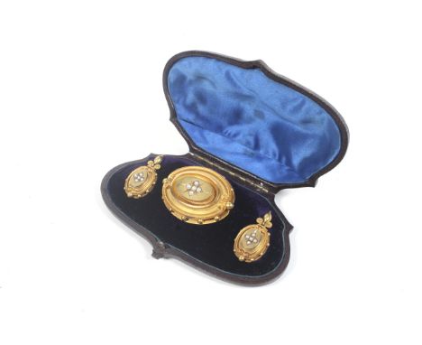 A pair of mid Victorian gold and half-pearl oval pendent earrings and a matching brooch. Each with a central half-pearl five 