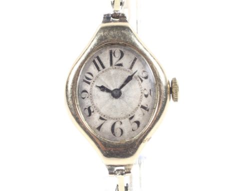 A Swiss 14ct gold tonneau-shaped bracelet watch, circa 1930. The silvered engine-turned dial with black Arabic numerals, the 